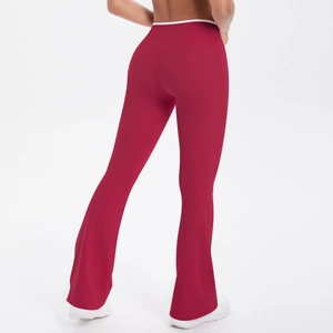 Detail of high-waist yoga flared pants with white contrast piping on red elastic fabric