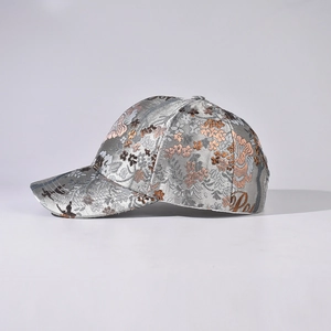 Silver-gray baseball cap with golden Chinese floral jacquard pattern and satin finish