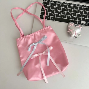 Detailed macro view of pink satin tote bag with elegant silk bows and soft texture