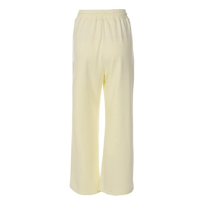 Détail d'un pantalon large jaune clair avec taille élastique et texture de tissu de qualité
