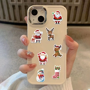 Christmas stickers with Santa and reindeer patterns applied on a beige mobile phone case