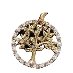 Golden Tree of Life brooch with sparkling white rhinestones in a circular frame
