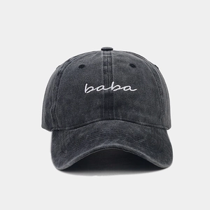Detail of dark grey washed cotton baseball cap with white 'baba' embroidery on front