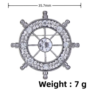 Detail view of silver ship wheel brooch showing 35.7mm diameter and 7g weight measurements