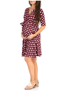 Detail of burgundy polka dot maternity dress featuring a V-neck and waist tie design