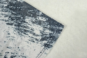 Detail of double-needle stitching and monochrome abstract print on dress hem
