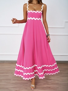 Detail of elegant scalloped white trim on a pink summer maxi dress with thin straps