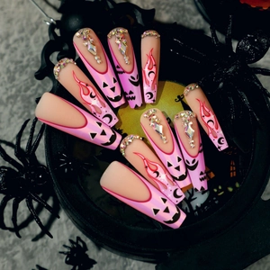 Pink Halloween coffin press on nails featuring pumpkin face, flames, and rhinestones décor