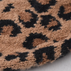 Knitted winter beanie with leopard print cuff and plush pompom for women
