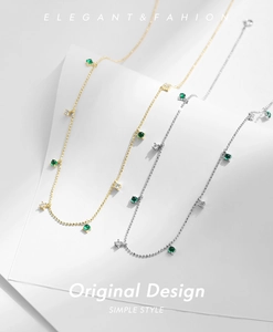 Detail of S925 silver necklaces with emerald green stones and zircon accents on fine chains
