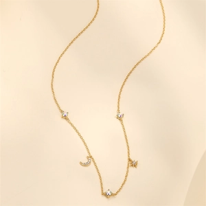 Detail of S925 silver gold necklace featuring star and moon pendants with colorful crystals