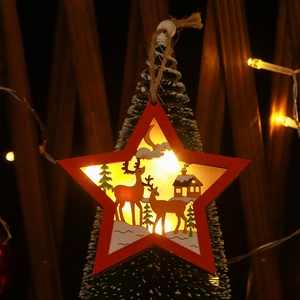 Close-up of a lit wooden star ornament with reindeer silhouette and LED warm glow