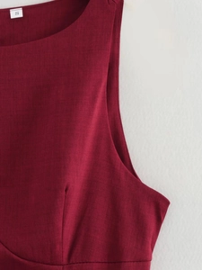 Macro detail of wine red round neck sleeveless dress showing fabric texture and size S tag