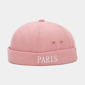 Detailed embroidery of PARIS text on pink cotton canvas docker cap with texture