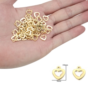 Macro shot of gold heart jewelry charm pendants with 10mm x 9mm size measurement guide