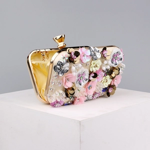 Close-up of floral evening bag with pink and yellow beaded flowers and gold chain