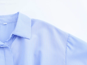 Detail shot of the collar and shoulder seams on this blue and white striped shirt