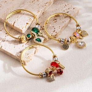 Golden twisted bead bracelets set with colorful heart, crown pendants and gemstones