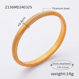 Detailed macro view showing the 0.8cm width and 14g weight of the gold titanium cuff
