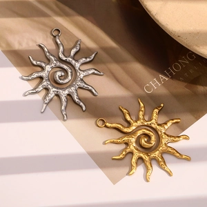 Artistic close-up of sun-shaped gold and silver pendants with textured hammer finish