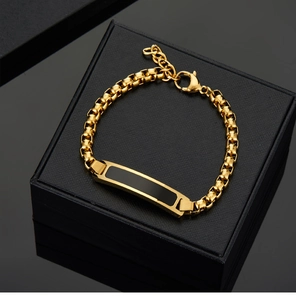 Detail of 18K gold-plated stainless steel Cuban link bracelet with black inlay and clasp