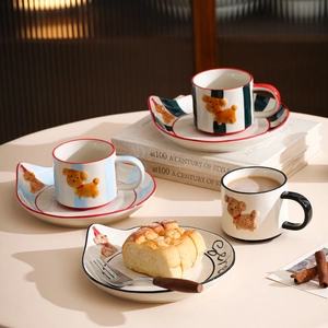 Close-up of hand-painted dog ceramic coffee cup set with striped patterns and wavy saucers