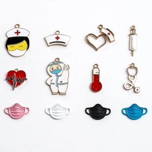 Set of 12 medical themed enamel charms including nurse hat and stethoscope on white background