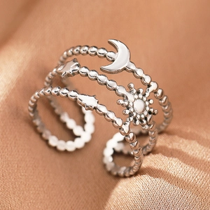 Macro detail of bohemian stainless steel ring featuring sun, moon, and star patterns