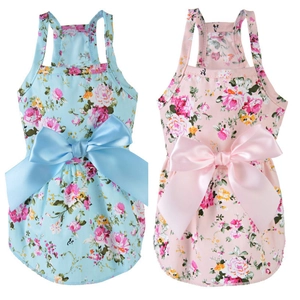 Detail view of floral pet dresses in blue and pink with large satin bows on the back