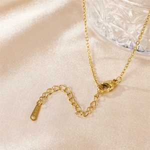 Macro shot of gold stainless steel necklace with adjustable chain and lobster clasp detail