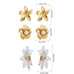 Three pairs of floral 18k gold earrings with pearls and sunflowers on white background