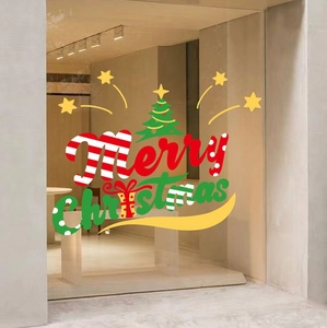 Close-up of Merry Christmas window sticker with tree and star motifs on glass