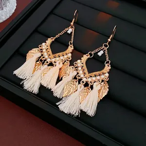 Bohemian hollow round earrings with leaf pendants and beige silk tassels in golden finish