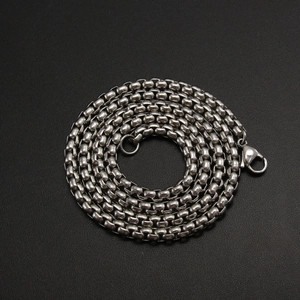 Polished silver stainless steel round box chain necklace with lobster clasp on black background