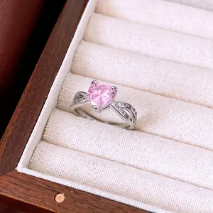Elegant silver open ring featuring a pink heart zircon and hollow interlaced band design