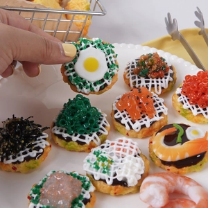 Modelli realistici di torte di gamberetti e pesce esposti su un piatto bianco