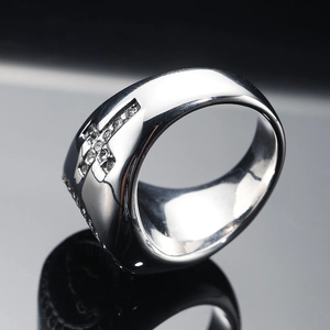 Macro shot of silver vintage gothic cross ring with white zircon pave setting