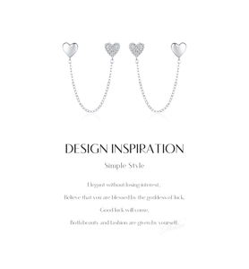 Macro detail of asymmetric S925 silver heart chain earrings with zircon pave and mirror finish