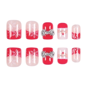Christmas press-on nails featuring Santa patterns and 3D silver bow-knot accessories