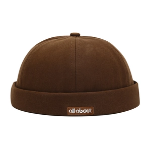 Retro dark brown cotton docker cap with embroidered all about patch on white background