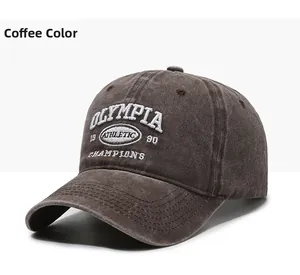 Detailed close-up of brown vintage baseball cap with OLYMPIA white 3D embroidery detail