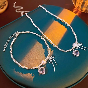 Elegant silver heart necklace and bracelet set with purple zircon and bow pendants