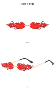 Detail view of gold-red rimless flame sunglasses with sparkling crystal embellishments