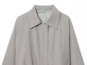Detail of grey pinstripe jacket collar and zip closure with clean stitching