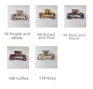 Detailed view of large acetate hair claws in various marble and tortoiseshell patterns