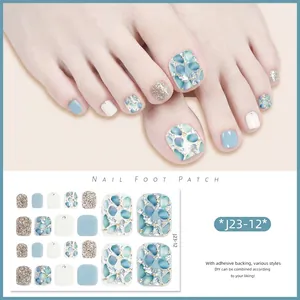 Detail of sparkling blue and silver glitter foot nail patches with gold foil textures