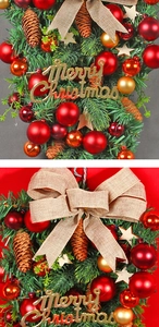 Detail of Christmas wreath with red and gold baubles, pine cones, and a burlap bow