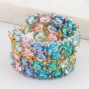 Macro detail of hoop earrings with vibrant colorful marquise-cut cubic zirconia gemstones