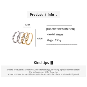Macro detail of geometric U-shaped Cuban link hoop earrings in copper gold and silver