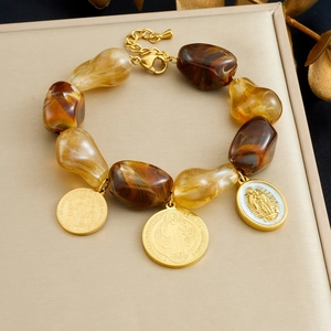 Maillard beaded bracelet with amber resin charms and golden religious relief pendants